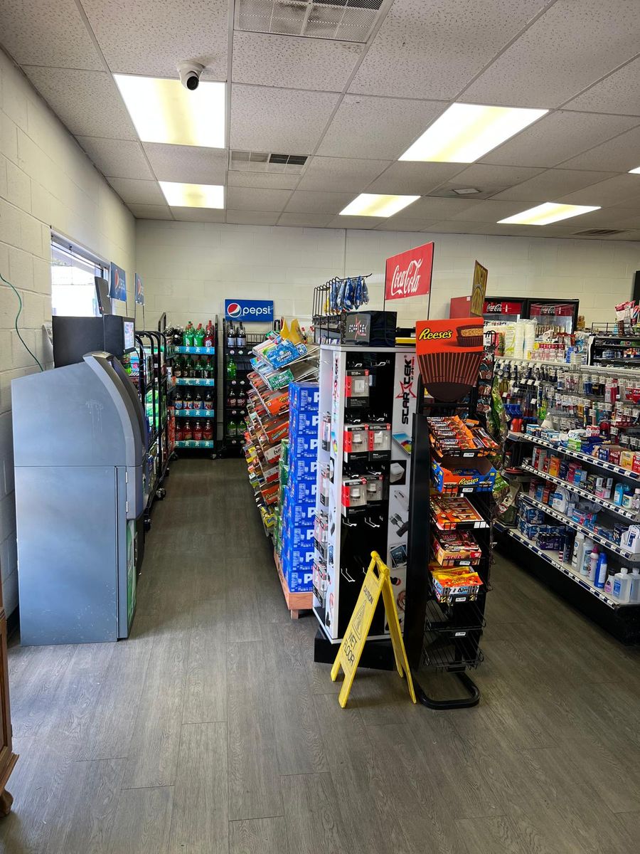 Aisles with drink coolers along the back wall