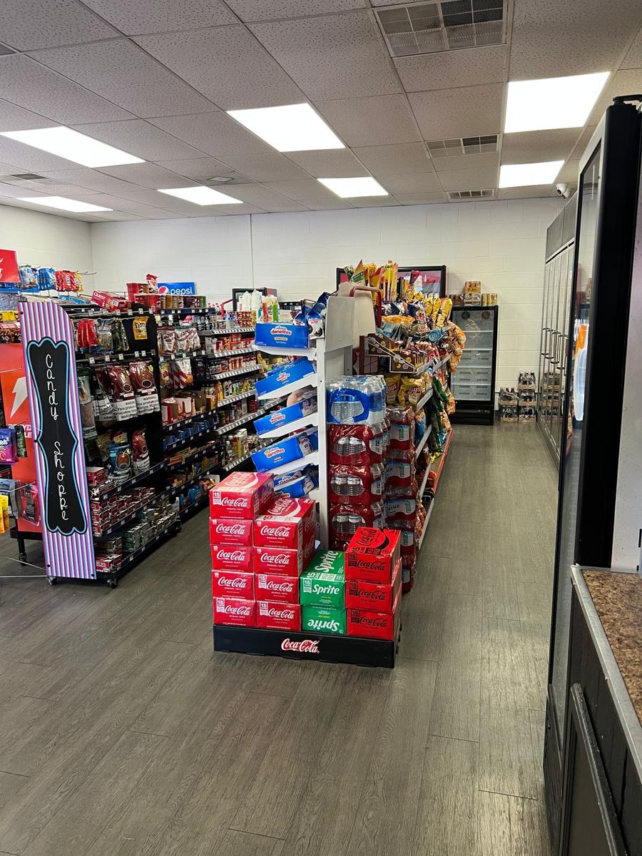 Store aisle with chips, candy and a Coca-Cola display